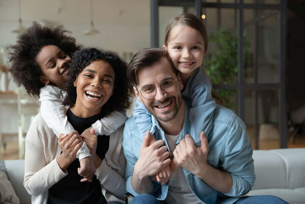 Happy couple smiling with two children